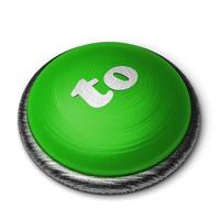 a la palabra en el botón verde aislado en blanco foto