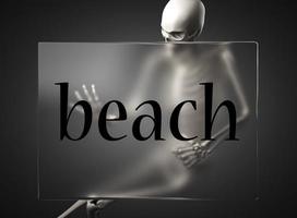 beach word on glass and skeleton photo