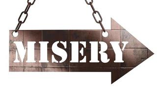 misery word on metal pointer photo