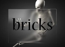 bricks word on glass and skeleton photo