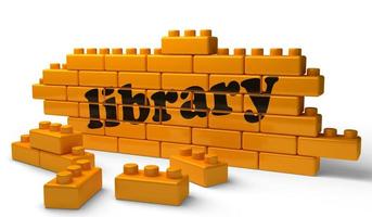 library word on yellow brick wall photo