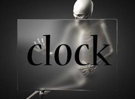 clock word on glass and skeleton photo