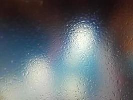 Water drops on window with blur background photo