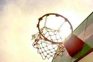 Wooden basketball hoop with sunset background photo