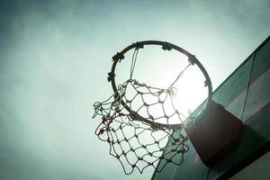 Wooden basketball hoop during sunset. photo