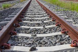 railroad tracks with rust on rock background photo