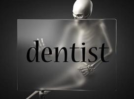 palabra de dentista en vidrio y esqueleto foto