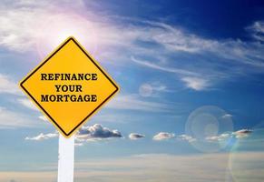 Text for Refinance your mortgage on yellow road sign