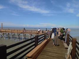 Medan, Indonesia,  Nov 02 2021 wooden bridge by the beach photo