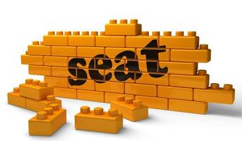 seat word on yellow brick wall photo