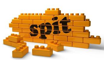 spit word on yellow brick wall photo