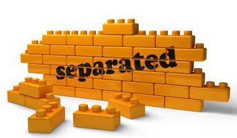 separated word on yellow brick wall photo