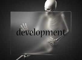palabra de desarrollo en vidrio y esqueleto foto
