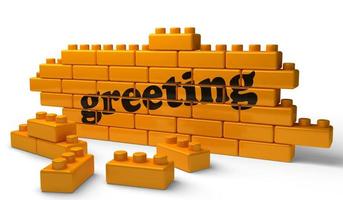 greeting word on yellow brick wall photo