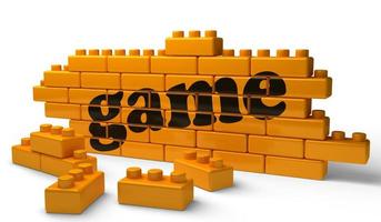 game word on yellow brick wall photo