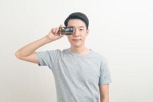 young Asian man holding credit card photo