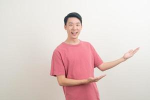 Asian man with hand pointing or presenting on white background photo