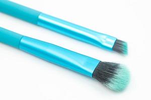 Blue Cosmetic Brushes above white background photo