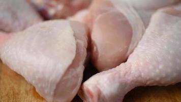 Raw, fresh chicken thigh, spinning in a circle on a chopping board. video
