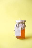 fresh honey in a glass jar with a paper empty label photo