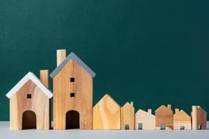 set of wooden house and tree decoration in village on grey floor and green background photo