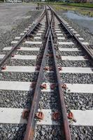 railroad tracks with rust on rock background photo