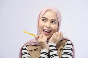 A young Muslim woman using toothbrush with beautiful teeth , Dental health care concept photo