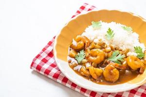 Shrimps in curry sauce on rice photo