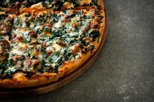 spinach and cheese pizza on wood tray