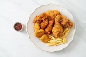 fried chicken with french fries and nuggets on plate photo