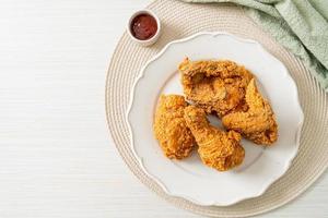 fried chicken with ketchup on plate photo