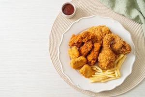 fried chicken with french fries and nuggets on plate photo