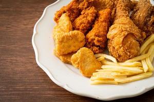 fried chicken with french fries and nuggets on plate photo