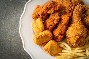 fried chicken with french fries and nuggets on plate photo