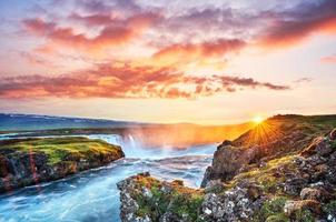 The picturesque sunset over landscapes and waterfalls. Kirkjufell mountain photo