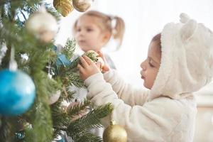 Portrait of happy girl decorating Christmas tree photo