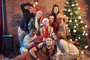 Group of friends celebrating new year indoors photo