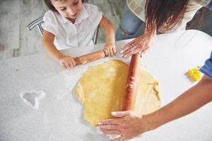 Mom and daughter make homemade cookies. photo