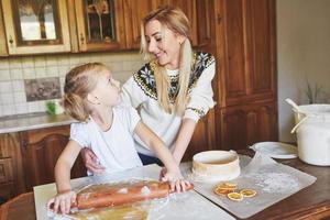 Happy girl with her mom dough photo