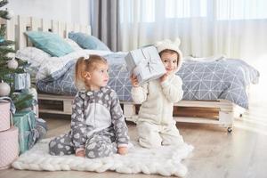 Two sisters in a Christmas decorated studio in pastel colors photo