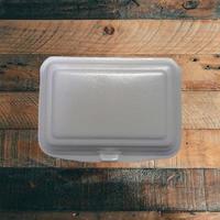 Styrofoam container with wood background photo
