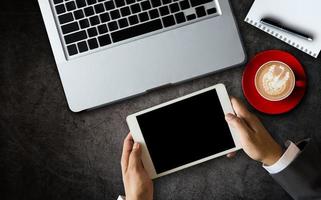 Top view.Business analysis and strategy concept. Businessman analyzing financial data on smartphone and laptop photo