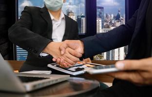 Business handshake closing a deal with blur background of people