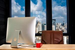 Front view workspace with computer, smartphone and tablet on white desk with blurred background as concept photo