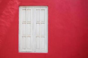 Old white wood window on red wall photo