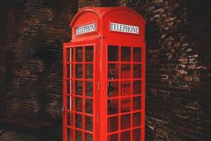 Vintage red telephone booth at public area photo