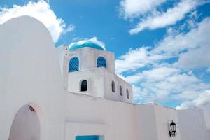 Famous blue domes of amazing Santorini architectural with beautiful sky background. photo