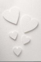 Pattern of white styrfoam hearts on the sheet of a white styrfoam photo