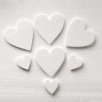 Pattern of white styrfoam hearts on the sheet of a white styrfoam photo