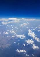 Flying above the clouds over the countryside of Thailand. photo